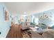 Bright living room featuring coastal decor, wood floors, and comfortable seating at 8710 Sw 91St Pl # E, Ocala, FL 34481