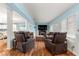 Spacious living room with a view into the kitchen and comfortable seating arrangement at 8710 Sw 91St Pl # E, Ocala, FL 34481