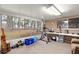 Bright sun room with large windows offering great views of nature, with exercise equipment at 8710 Sw 91St Pl # E, Ocala, FL 34481