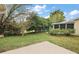 Fenced backyard featuring lush landscaping, green lawn, and concrete patio at 9025 Sw 94Th Ln # C, Ocala, FL 34481