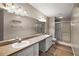 Bathroom featuring double sinks, large mirror and vanity with tile flooring and a shower at 9025 Sw 94Th Ln # C, Ocala, FL 34481