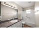 This bathroom features white cabinets, white tiling, and a shower-tub combo at 9025 Sw 94Th Ln # C, Ocala, FL 34481