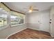 This dining room features hardwood floors, soft gray paint and views of the front yard at 9025 Sw 94Th Ln # C, Ocala, FL 34481