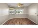 This dining room features hardwood floors, soft gray paint and views of the front yard at 9025 Sw 94Th Ln # C, Ocala, FL 34481