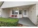 Inviting front porch with a bench and well-maintained landscaping, providing a welcoming entrance to the home at 9025 Sw 94Th Ln # C, Ocala, FL 34481