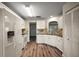 Remodeled kitchen with white cabinets, granite countertops, stainless appliances, and wood floors at 9025 Sw 94Th Ln # C, Ocala, FL 34481