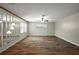 Spacious living room with contemporary lighting fixtures, ceiling fan, and wood-look flooring at 9025 Sw 94Th Ln # C, Ocala, FL 34481