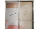 Tiled shower stall with glass doors and seat featuring white tiles and accent colors at 9025 Sw 94Th Ln # C, Ocala, FL 34481
