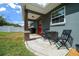 Relaxing back patio with outdoor table and chairs, ideal for enjoying the outdoors at 9436 Se 163Rd St, Summerfield, FL 34491