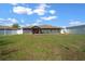 Expansive backyard featuring a well-maintained lawn and white vinyl privacy fence at 9436 Se 163Rd St, Summerfield, FL 34491