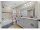 Beautiful bathroom featuring double sink vanity, granite countertops, and a tiled shower and tub at 9436 Se 163Rd St, Summerfield, FL 34491