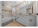 Updated bathroom featuring double sink vanity, granite countertops, and a tiled shower and tub at 9436 Se 163Rd St, Summerfield, FL 34491