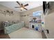 Bright bedroom featuring day bed, fan, and a makeup vanity bathed in natural light from the window at 9436 Se 163Rd St, Summerfield, FL 34491