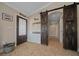 Welcoming entryway with sliding barn doors, tiled floors, and abundant natural light at 9436 Se 163Rd St, Summerfield, FL 34491