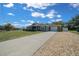 Well-maintained home with a long driveway, landscaping, and an inviting front entrance at 9436 Se 163Rd St, Summerfield, FL 34491
