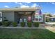 Charming front porch with rocking chairs, a ceiling fan, and manicured bushes at 9436 Se 163Rd St, Summerfield, FL 34491