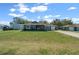Charming single-story home with a well-manicured lawn, cute bushes, and an inviting front entrance at 9436 Se 163Rd St, Summerfield, FL 34491