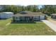 Charming single-story home with a well-manicured lawn, cute bushes, and an inviting front entrance at 9436 Se 163Rd St, Summerfield, FL 34491
