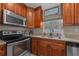Featuring stainless steel appliances, custom wood cabinets, and granite counters, this kitchen is ready for cooking at 9436 Se 163Rd St, Summerfield, FL 34491