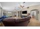Open living room featuring a plush leather sofa, large windows, and stylish sliding barn doors at 9436 Se 163Rd St, Summerfield, FL 34491
