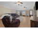 Bright living room showcasing a large leather sectional sofa and natural light from the large windows at 9436 Se 163Rd St, Summerfield, FL 34491