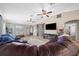 Inviting living room with a comfortable leather sectional sofa and large windows offering ample natural light at 9436 Se 163Rd St, Summerfield, FL 34491