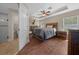 Spacious main bedroom suite with wood floors, fan, and an ensuite bathroom featuring a glass shower at 9436 Se 163Rd St, Summerfield, FL 34491