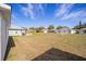 Large backyard featuring a vast lawn area, with views of neighboring homes and the clear blue sky at 9575 Sw 92Nd Street Rd, Ocala, FL 34481