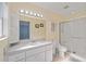 Bright bathroom with a walk-in shower, white vanity with storage, and a well-lit mirror at 9575 Sw 92Nd Street Rd, Ocala, FL 34481