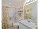 Clean bathroom features a shower-tub combo, single sink vanity, and neutral decor with seashell accents at 9575 Sw 92Nd Street Rd, Ocala, FL 34481