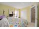 Cozy bedroom with a patterned bedspread, a large closet, and a window with natural light at 9575 Sw 92Nd Street Rd, Ocala, FL 34481