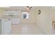 Light-filled kitchen with tile floors, showcasing the dining area and kitchen window at 9575 Sw 92Nd Street Rd, Ocala, FL 34481