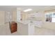 Well-lit kitchen features white cabinetry, tile flooring, and an open view to the front door at 9575 Sw 92Nd Street Rd, Ocala, FL 34481