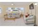 Bright living room with large windows, comfortable couches, and tile floors, ideal for Gathering time and relaxation at 9575 Sw 92Nd Street Rd, Ocala, FL 34481