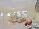 Bright living room with a large window that offers an outdoor view, tiled floors, and comfortable seating at 9575 Sw 92Nd Street Rd, Ocala, FL 34481