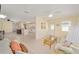 Bright living room featuring tile floors, a ceiling fan, and an open floor plan with access to the kitchen at 9575 Sw 92Nd Street Rd, Ocala, FL 34481