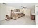 Spacious living room featuring neutral color palette, tile floors, and a ceiling fan for comfortable living at 9575 Sw 92Nd Street Rd, Ocala, FL 34481