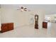 Living space with tile floor, vintage clock and view of the kitchen at 9575 Sw 92Nd Street Rd, Ocala, FL 34481