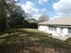 Lush backyard with mature trees and open lawn space, offering privacy and room for recreation at 9610 Sw 198Th Cir, Dunnellon, FL 34432