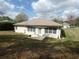 Spacious backyard featuring a patio area, perfect for outdoor dining and relaxation at 9610 Sw 198Th Cir, Dunnellon, FL 34432
