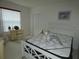 Neutral bedroom with a dresser and comfortable bed near a window at 9610 Sw 198Th Cir, Dunnellon, FL 34432