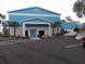 Commercial building featuring a blue and white exterior with landscaping at 9610 Sw 198Th Cir, Dunnellon, FL 34432