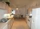 Functional kitchen with white appliances, ample counter space, and convenient access to the dining area at 9610 Sw 198Th Cir, Dunnellon, FL 34432