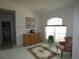 Cozy sitting room with comfortable chair, decorative rug, and dresser near a window at 9610 Sw 198Th Cir, Dunnellon, FL 34432