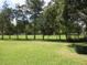 A grassy back yard is fully fenced for pets and children to enjoy at 11792 Sw 137Th Loop, Dunnellon, FL 34432