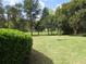 Beautiful backyard featuring a large green lawn and well manicured greenery at 11792 Sw 137Th Loop, Dunnellon, FL 34432
