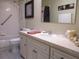Bright bathroom with tub and shower combination, white vanity and drawers for storage at 11792 Sw 137Th Loop, Dunnellon, FL 34432