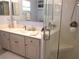 Bright bathroom with a single sink vanity and glass shower with a seat at 11792 Sw 137Th Loop, Dunnellon, FL 34432