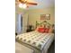 Bedroom with floral bedspread, curtains, and view through doorway at 11792 Sw 137Th Loop, Dunnellon, FL 34432