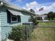 Exterior view of home with chain link fence and flagpole with American flag at 11792 Sw 137Th Loop, Dunnellon, FL 34432